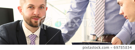 Handsome bearded businessman in suit and tie during meeting 69785834