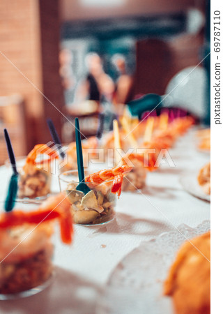 Table full of food at a party Table full of food at a party 69787110