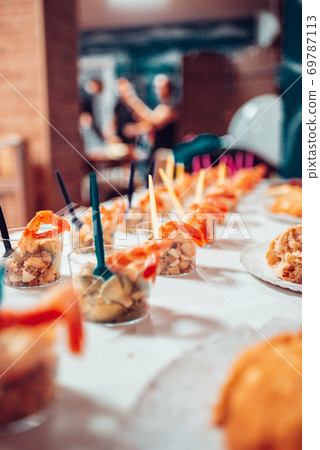 Table full of food at a party Table full of food at a party 69787113