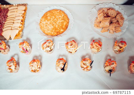 Table full of food at a party Table full of food at a party 69787115