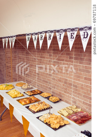 Table full of food at a party Table full of food at a party 69787118