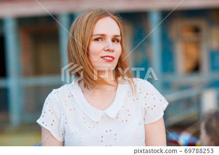 woman in stand old bridge, destroyed buildings. 69788253