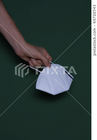 Woman's hand with protective mask 69788543