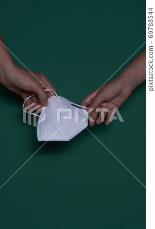 Child and woman's hand with protective mask 69788544
