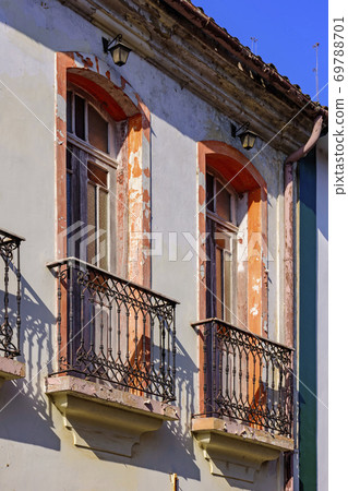 Window of old colonial style house with balcony and colorful frame 69788701