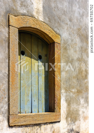 Historic church window in colonial style with stone frame Historic church window in colonial style with stone frame 69788702