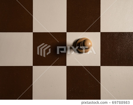Chess pawn view from top one, board of cells, shadow falls to the side Chess pawn view from top one, board of cells, shadow falls to the side 69788983