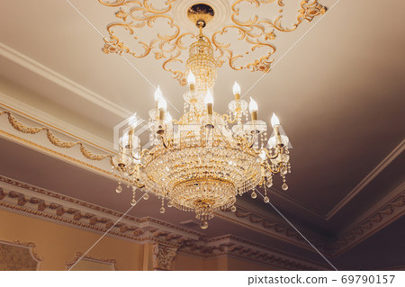 Chrystal chandelier lamp on the ceiling in Dining room Adjusting the image in a Luxury tone .Decorative elegant vintage and Contemporary interior Concept. Chrystal chandelier lamp on the ceiling in Dining room Adjusting the image in a Luxury tone .Decorative elegant vintage and Contemporary interior Concept. 69790157