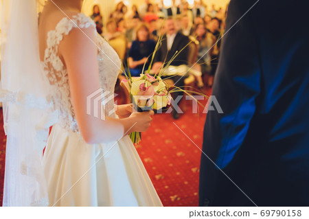 wedding bouquet of white lilies fashionable close-up in hands. wedding bouquet of white lilies fashionable close-up in hands. 69790158