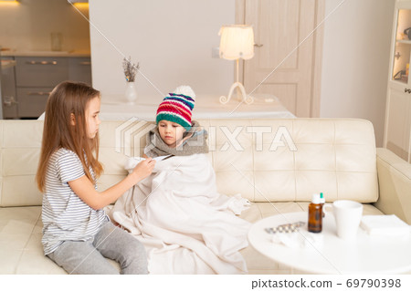 big sister measures temperature sick younger big sister measures temperature sick younger 69790398