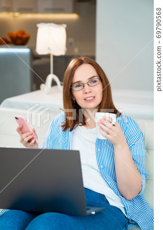 happy business woman drink tea and read messages. happy business woman drink tea and read messages. 69790568