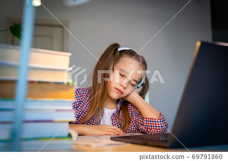 sleepy schoolgirl in headphones listen music 69791860