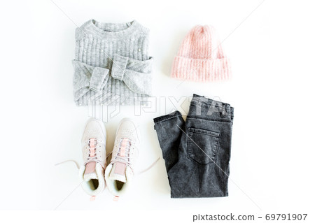 Women fashion clothes and accessories. Feminine youth collage, top view. Flat lay female style look with warm sweater, jeans, cap, sneakers. Top view. 69791907