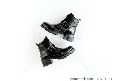 Black female boots on white background. Flat lay, top view minimal background. Fashion blog or magazine concept. 69791994