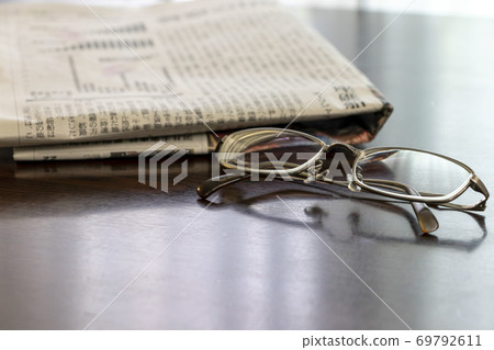 Newspaper and glasses Newspaper and glasses 69792611