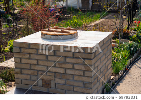 aboveground large brick tandir oven in the garden. aboveground large brick tandir oven in the garden. 69792831