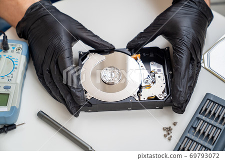 open Computer Hard Drive. screwdriver set. Hands. 69793072