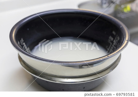 Soak the washed rice in water Soak the washed rice in water 69793581