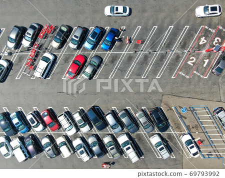 Aerial top view of parking lot at shopping mall with varieties of colored vehicles. 69793992