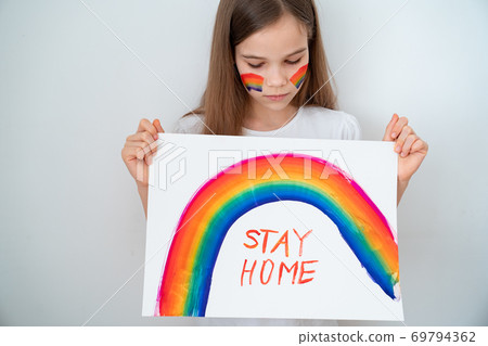 kid girl drew rainbow and poster stay home. kid girl drew rainbow and poster stay home. 69794362