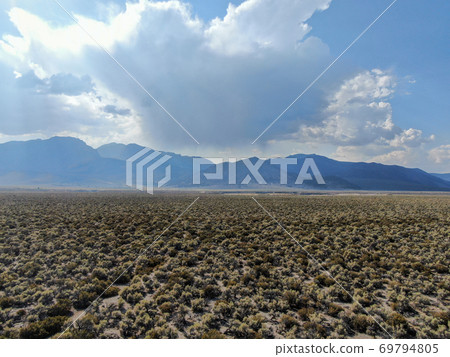 Aerial view of dusty dry desert land and mountain on the background in Lee Vining Aerial view of dusty dry desert land and mountain on the background in Lee Vining 69794805