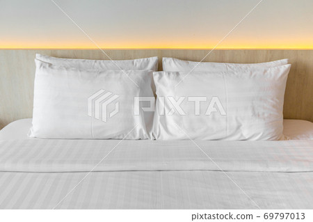White pillows on a bed Comfortable soft pillows. White pillows on a bed Comfortable soft pillows. 69797013