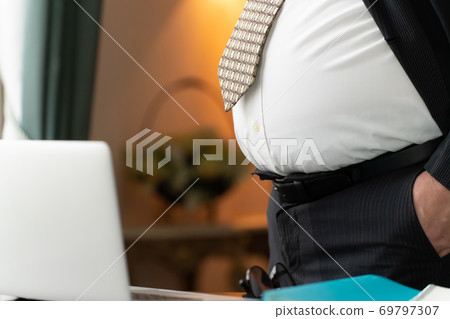 Obese businessman's belly 69797307