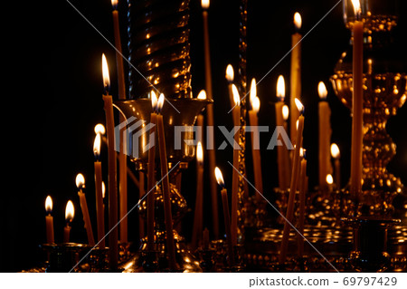 Large church candlestick with burning candles in orthodox church 69797429