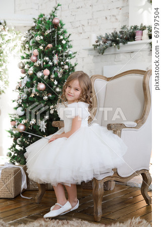 girl with magic wands sitting in chair. Christmas  69797504