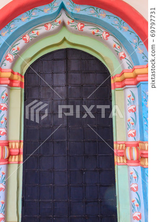 Ancient russian architecture. Close-up of arched metal door in russian style 69797731