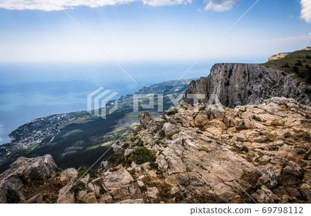 Stones on top of the Crimean mountains on the background of the valley on the Black sea in the fog 69798112