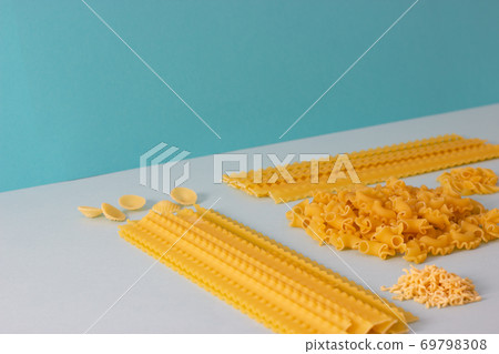 Different types of pasta, blue background. Different types of pasta, blue background. 69798308