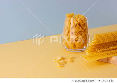 Different types of pasta, blue background. Different types of pasta, blue background. 69798310