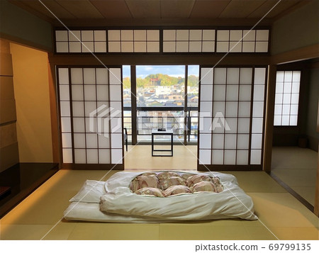 A traditional Japanese bedding in a room. 69799135