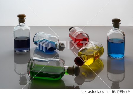 some small bottles with colored liquid some small bottles with colored liquid 69799659