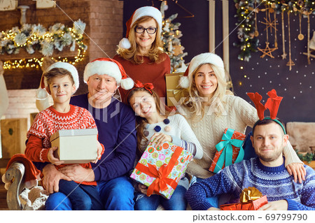 Big family in a room with a fireplace in Christmas. 69799790