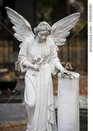 Closeup of stoned angel on tomb in a cemetery 69800090