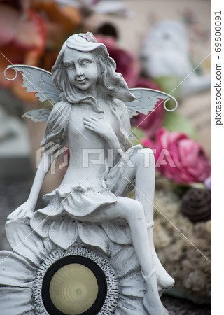 Closeup of stoned elf on tomb in a cemetery 69800091
