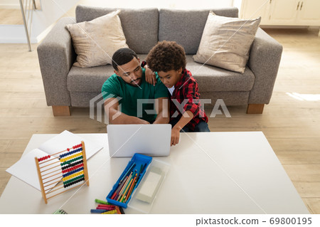 Father and son using laptop at home Father and son using laptop at home 69800195