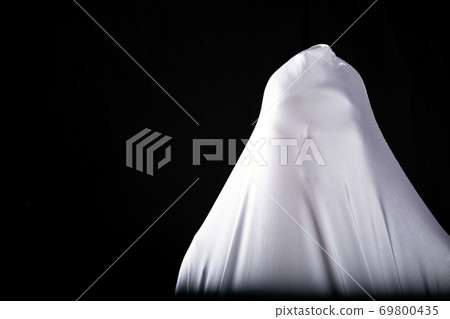 frightening ghost in a white sheet nightmare on black background frightening ghost in a white sheet nightmare on black background 69800435