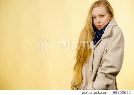 Woman wearing autumnal beige coat Woman wearing autumnal beige coat 69800633