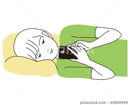 A boy lying down and staring at his smartphone A boy lying down and staring at his smartphone 69800949