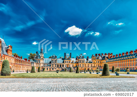 FONTAINEBLEAU, FRANCE - JULY 09, 2016 :Suburban Residence of the France Kings - facade beautiful Chateau Fontainebleau and surrounding his park. FONTAINEBLEAU, FRANCE - JULY 09, 2016 :Suburban Residence of the France Kings - facade beautiful Chateau Fontainebleau and surrounding his park. 69802017