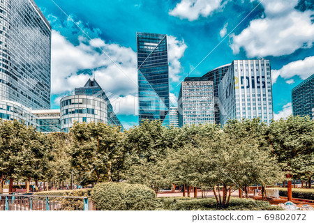 PARIS, FRANCE - JULY 06, 2016 :La Defense, Business Quarter with businessmen in the streets, area of Paris,  French financial center with skyscrapers and modern buildings. 69802072