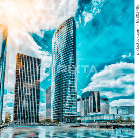 PARIS, FRANCE - JULY 06, 2016 :La Defense, Business Quarter with businessmen in the streets, area of Paris, French financial center with skyscrapers and modern buildings. PARIS, FRANCE - JULY 06, 2016 :La Defense, Business Quarter with businessmen in the streets, area of Paris, French financial center with skyscrapers and modern buildings. 69802486