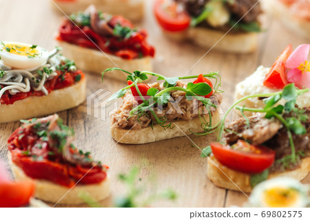 Assorted spanish tapas with different toppings Assorted spanish tapas with different toppings 69802575