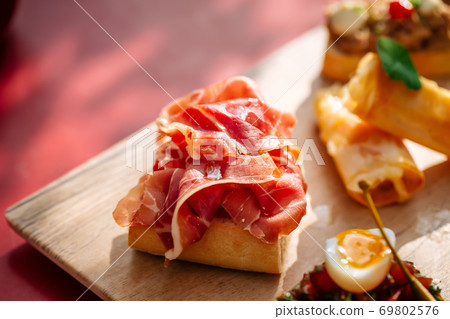 Assorted spanish tapas with different toppings Assorted spanish tapas with different toppings 69802576