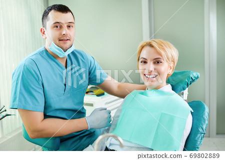 Dentist and patient are smiling Dentist and patient are smiling 69802889