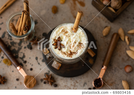 caffe latte with whipped cream, cinnamon and anise 69803416