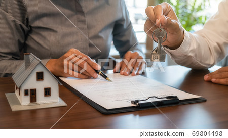 House model with agent and customer discussing for contract to buy, get insurance or loan estate. House model with agent and customer discussing for contract to buy, get insurance or loan estate. 69804498